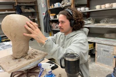 Students work on ceramics art projects