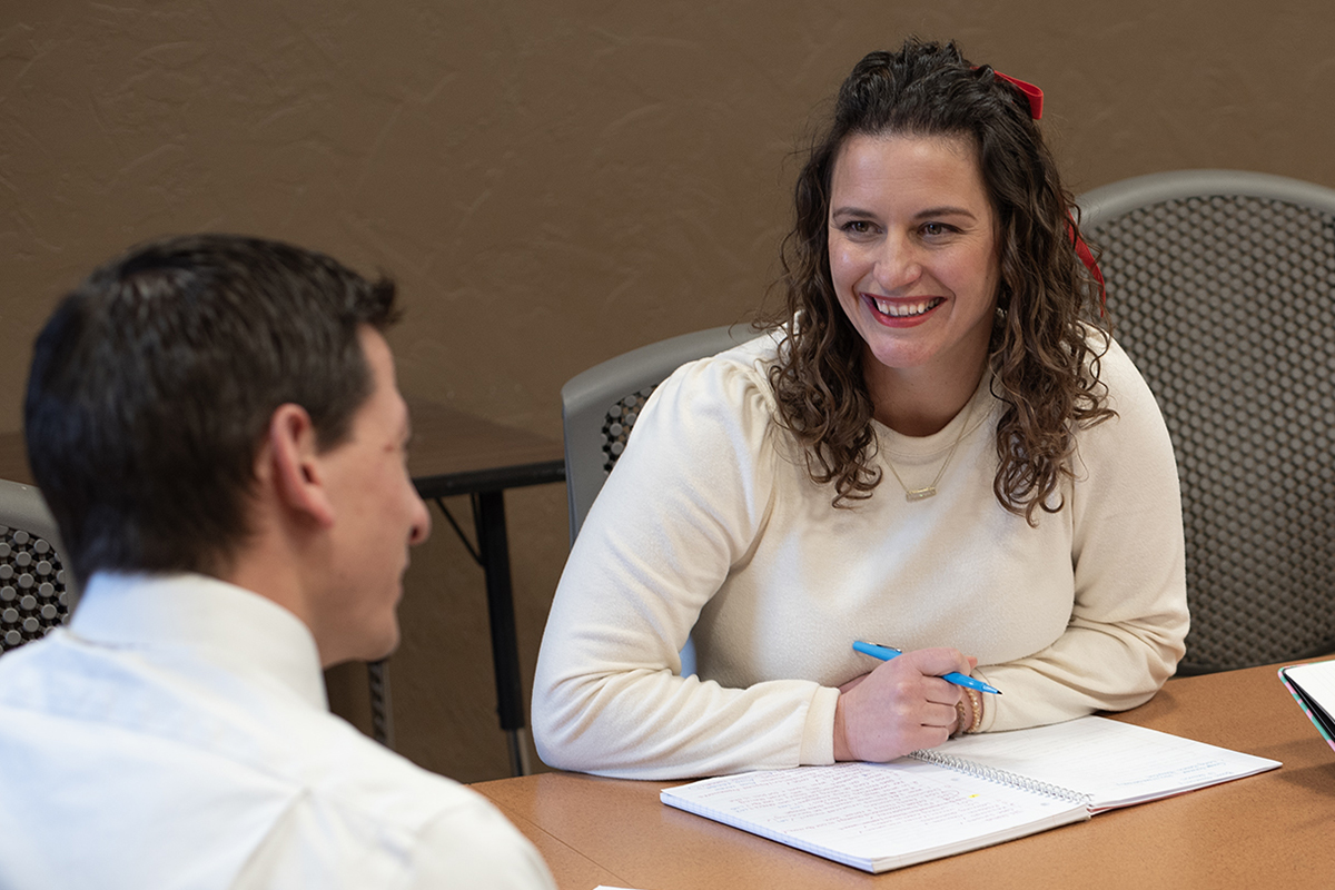 Graduate student works on project with peer