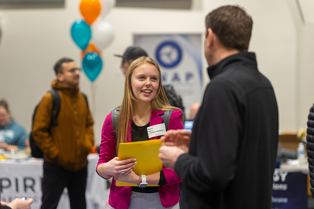 Student networking at career fair