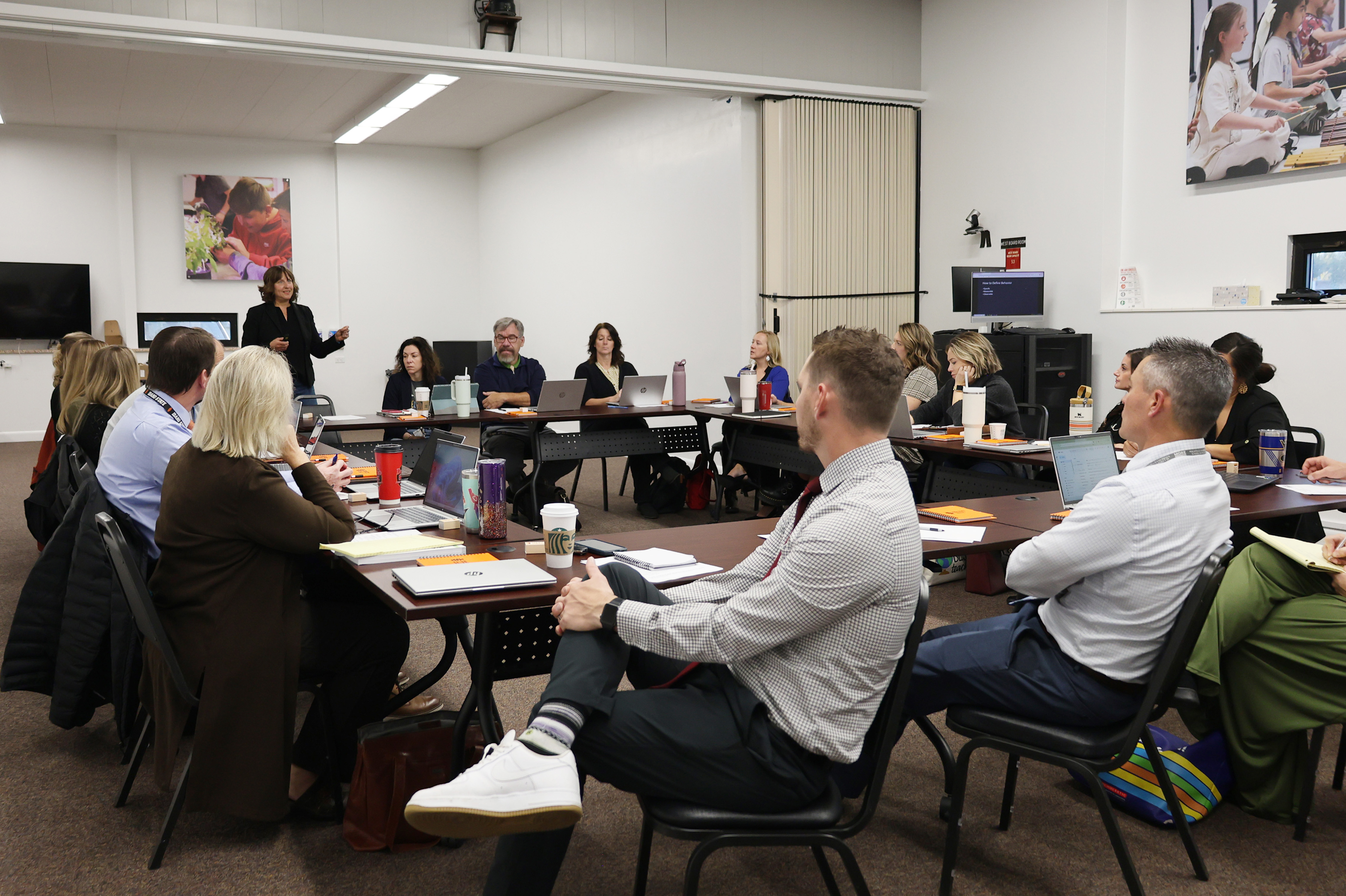 Faculty giving a presentation to school district administrators