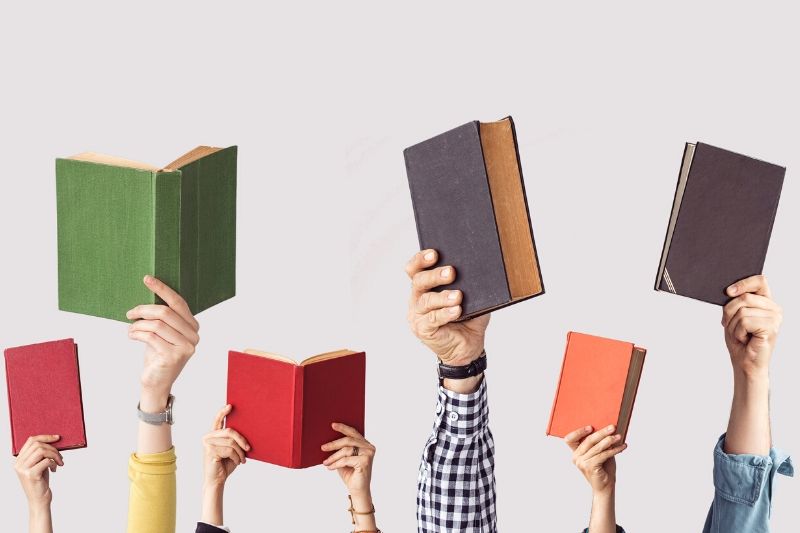 Hands holding books
