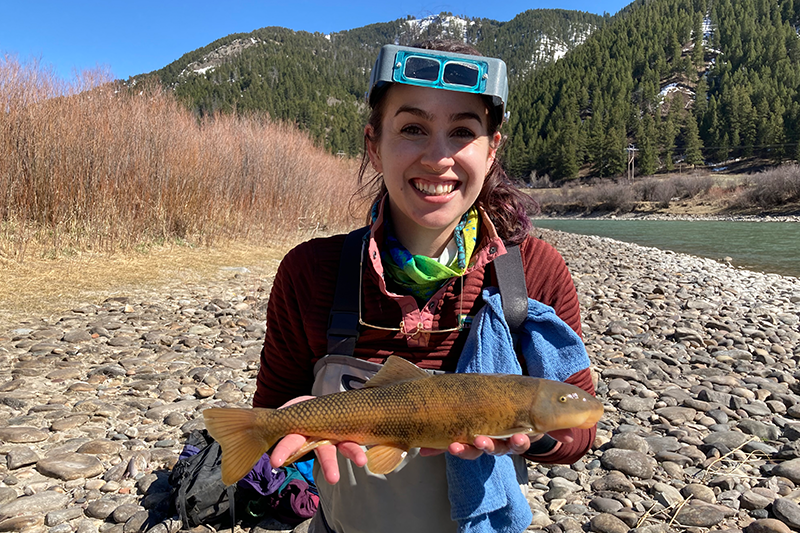Brandy Smith poses for a photo holding a green sucker near the Snake River.