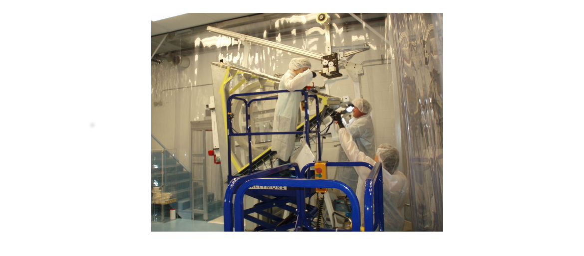 People in lab coats working on equipment
