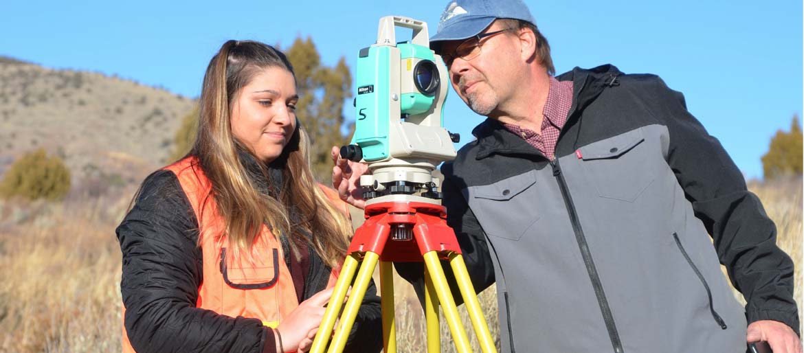 Robert Liimakka Clinical Assistant Professor / Coordinator Surveying and Geomatics Engineering Technology working with a student