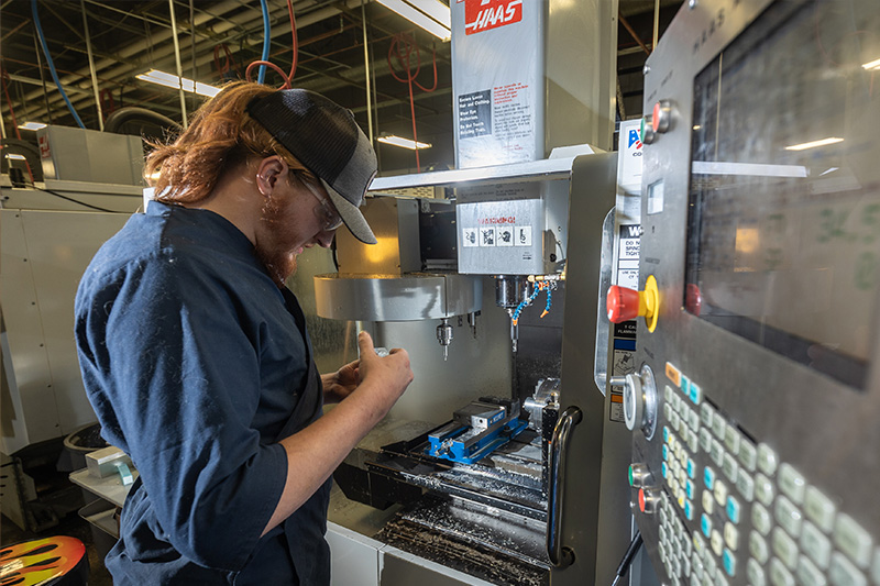 Computerized Machining Technology student working on a CNC machine