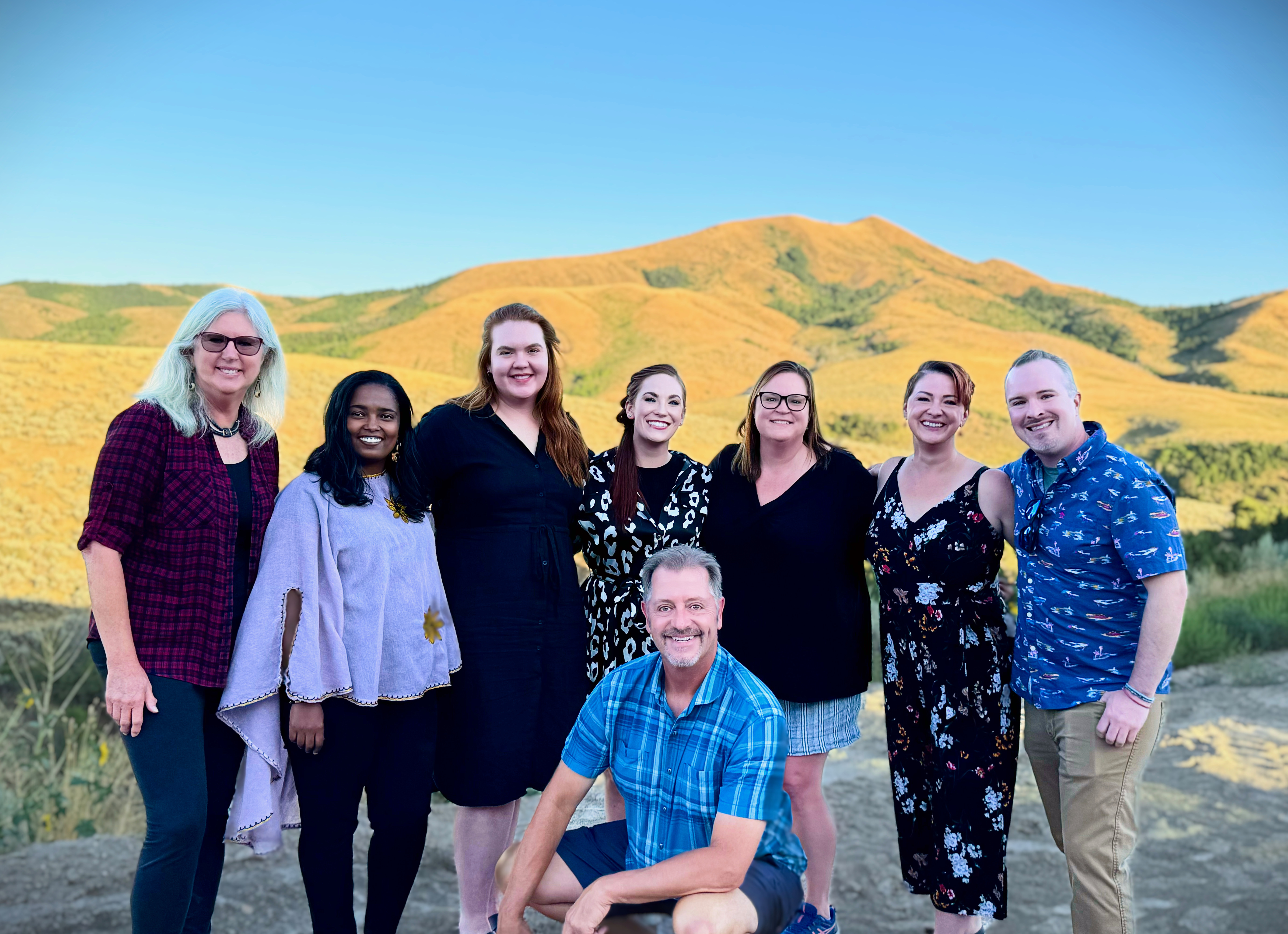 2024 Department of Counseling Faculty posing with mountains in background.