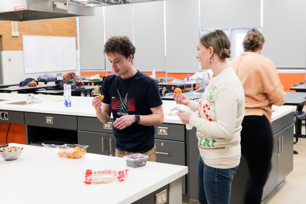 Student and faculty taste testing new fruit