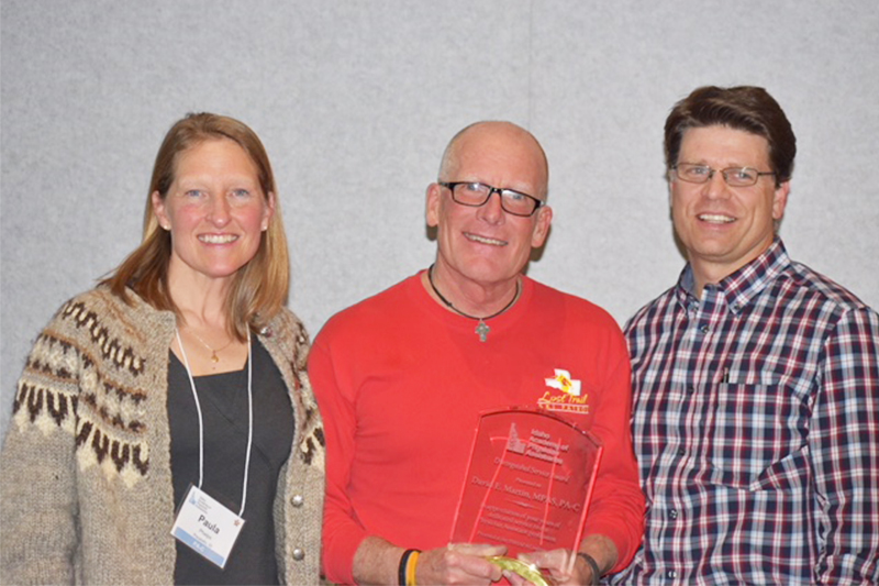 David Martin, Physician Assistant Studies faculty, with Paula Phelps and Jared Papa. Martin is holding his IAPA Distinguished Service Award.