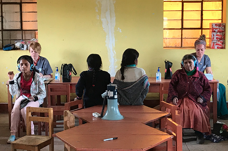 Cutline: ISU audiology student Bailey Neuhaus, left, and alumni Deanna Gende, right, providing hearing screenings in Peru