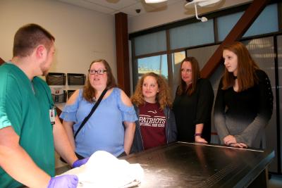 Students standing in lab at Meridian Health Science Experience Night