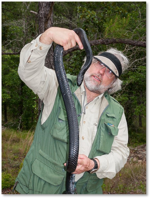 Chuck Peterson holding a long snake