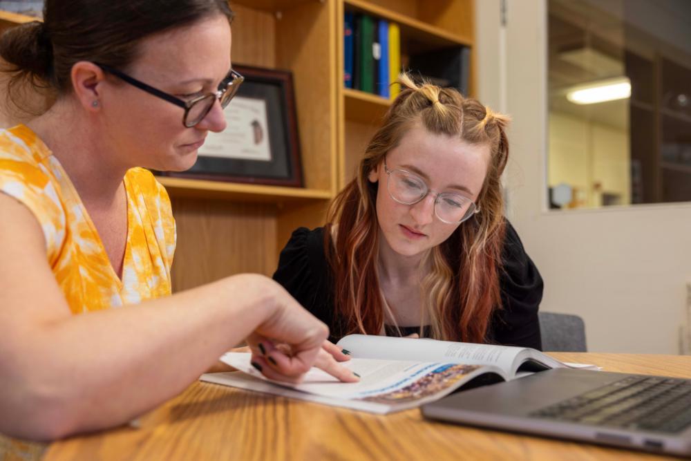 A professor helping a student in health sciences