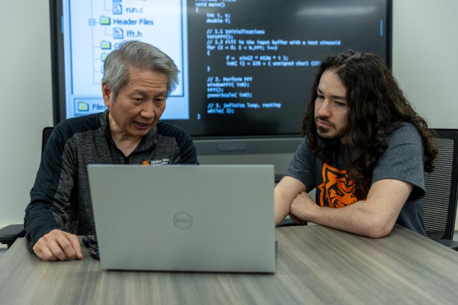 Teo Hanson, student at Idaho State University, and Steve Chiu, professor and chair of the computer science department, pose for photos on ISU's Pocatello campus