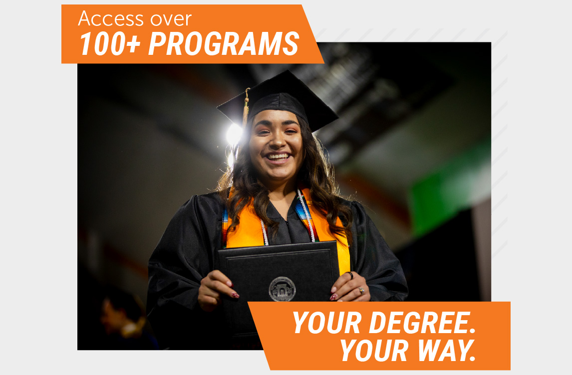 Smiling Idaho State University graduate in a black cap and gown with an orange stole, holding a diploma cover. Orange banners read, “Access over 100+ Programs” and “Your Degree. Your Way.”