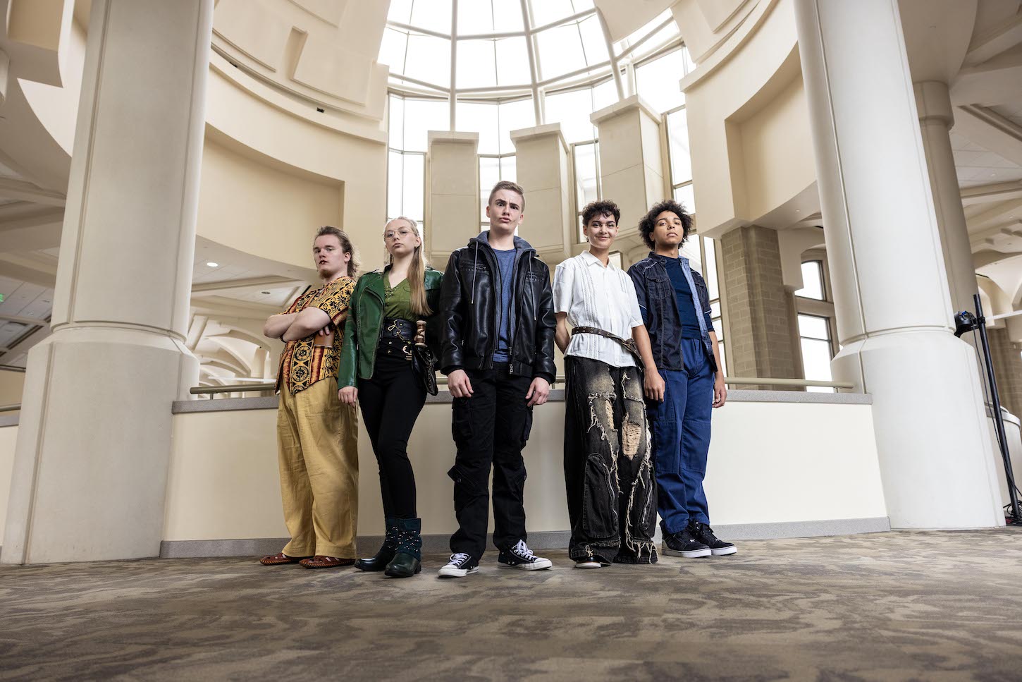 Four students stand in the performing arts center