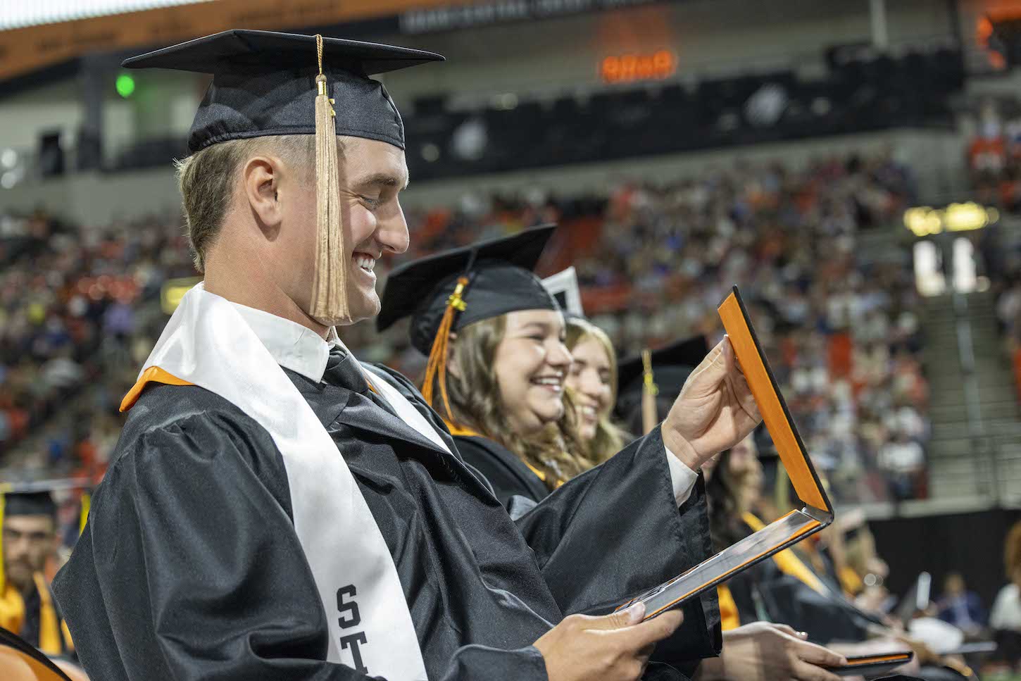 A man looks at his diploma