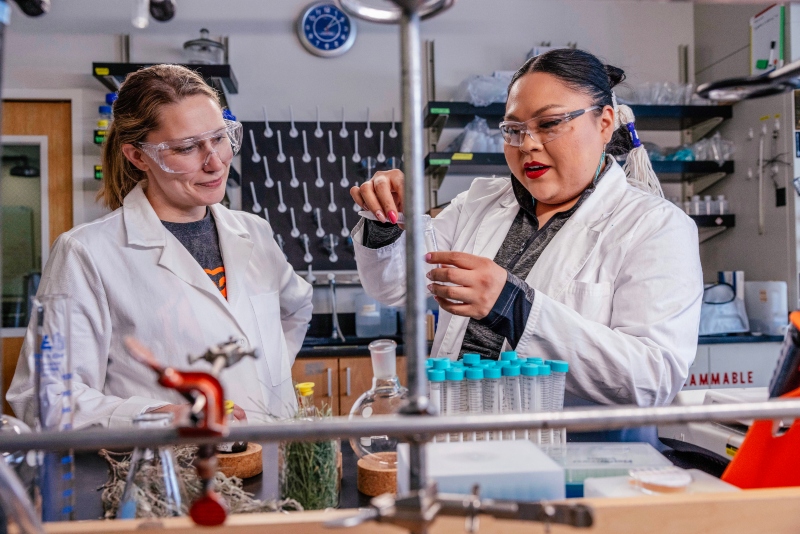 Miller (right) and Chemistry Professor, Cori Jenkins, Ph.D. (left) work together in the lab to develop renewable adhesives.