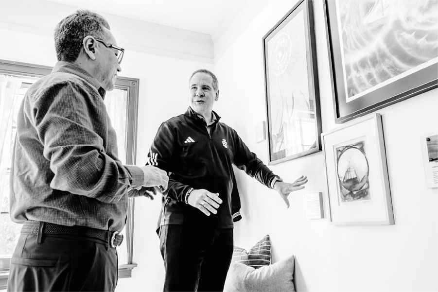 Ramon Murillo (left) with President Wagner (right), in front of the display of Murillo’s Native Artwork at the University House.